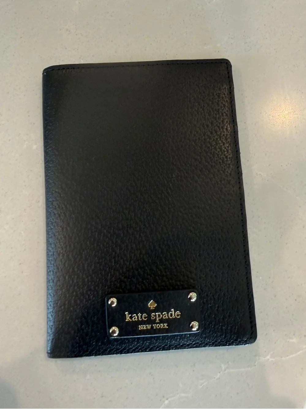kate spade Black Pebbled Leather Passport Cover with Gold Plaque